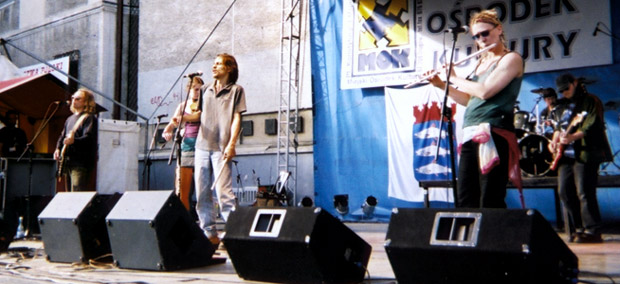 full band on stage in the sun in Poland